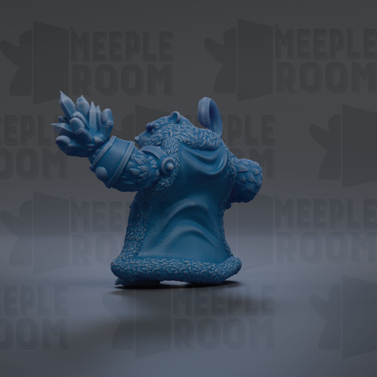 A blue, furry toy figure with a pointed hat and raised arm is the main focus of the image.