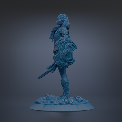 A blue statue of a female warrior standing on a base, holding a shield and sword.