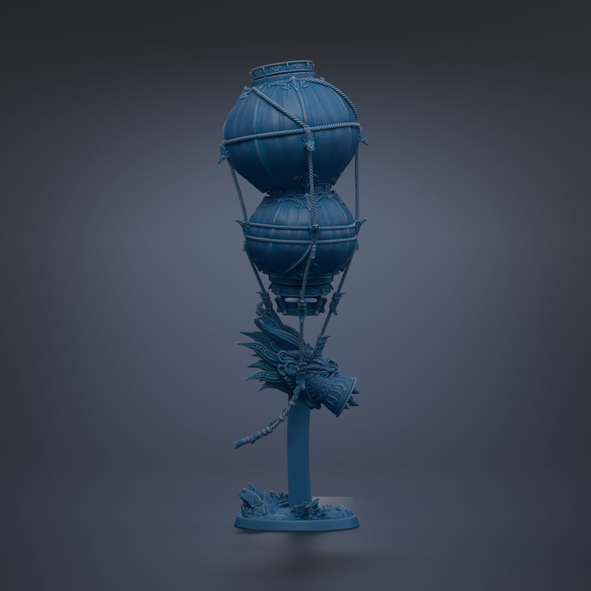 A blue, spherical object with a dragon-like design on it, standing on a base and appearing to be suspended in mid-air.