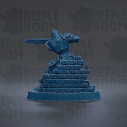 A blue figurine of a knight in armor, holding a sword, standing atop a pile of bricks.