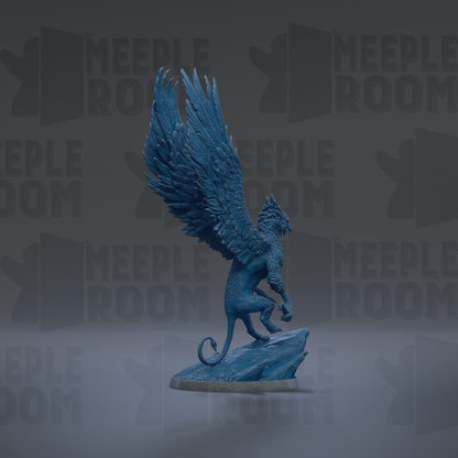 A blue winged statue of a mythical creature, possibly a dragon or a mythical beast, standing on a rock.