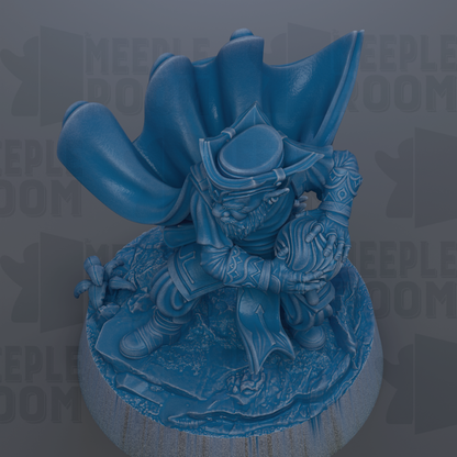 A blue figurine of a person with a cape and a hat, sitting on a base and holding a small object.