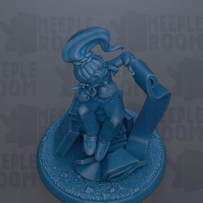 A blue figurine of a person sitting on a pedestal, holding a scroll.