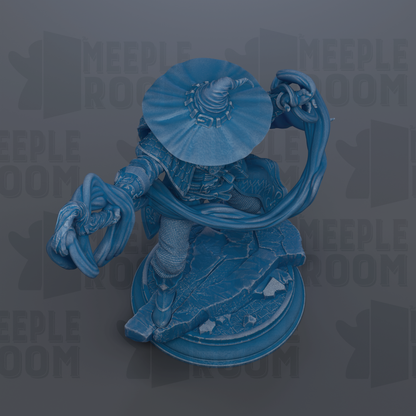 A blue figurine of a character with a large hat and a flowing cape, standing on a platform.