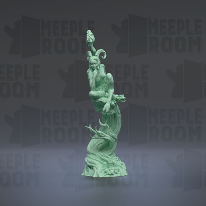 A green statue of a person sitting on a rock, with a bird perched on their head.