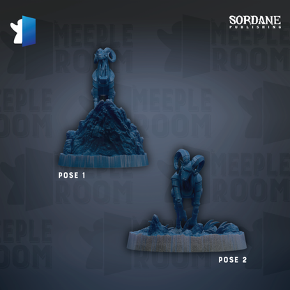 two blue figurines, one standing on a rock and the other kneeling on a rock, both placed on a gray surface.