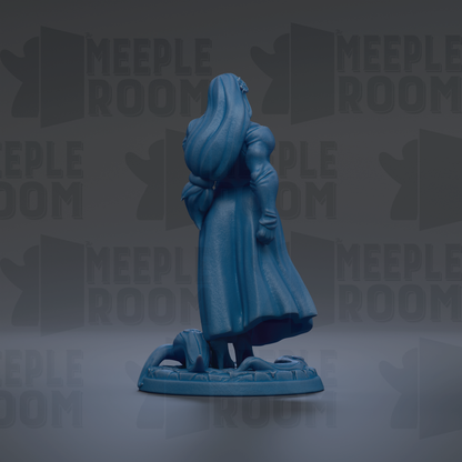 A blue figurine of a woman with long hair and a flowing dress stands on a base, facing away from the camera.
