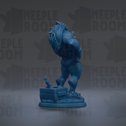 A blue figurine of a muscular, fantastical creature with long hair and a fierce expression, standing on a base with a crate and other objects.
