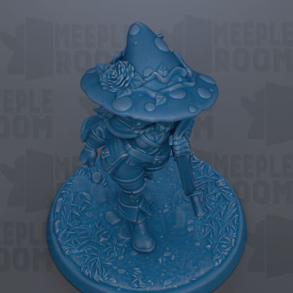 A blue figurine of a wizard or magical character, wearing a pointed hat with a rose, standing on a base with a leafy, textured surface.