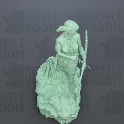 A green statue of a woman holding a spear and a skull, standing on a rock.