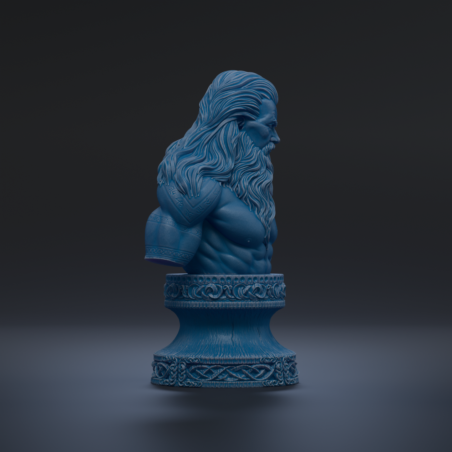 A blue bust sculpture of a bearded man with long hair, displayed on a decorative base.