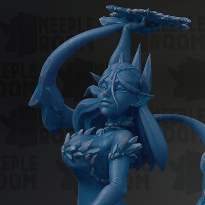 A blue, fantastical statue of a woman with an intricate headdress and ornate jewelry, holding a large object in her hand.