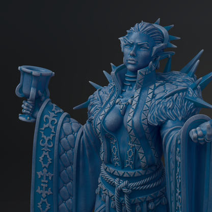 A detailed, blue-colored statue depicting a female figure with intricate patterns and designs, holding a cup in her hand.