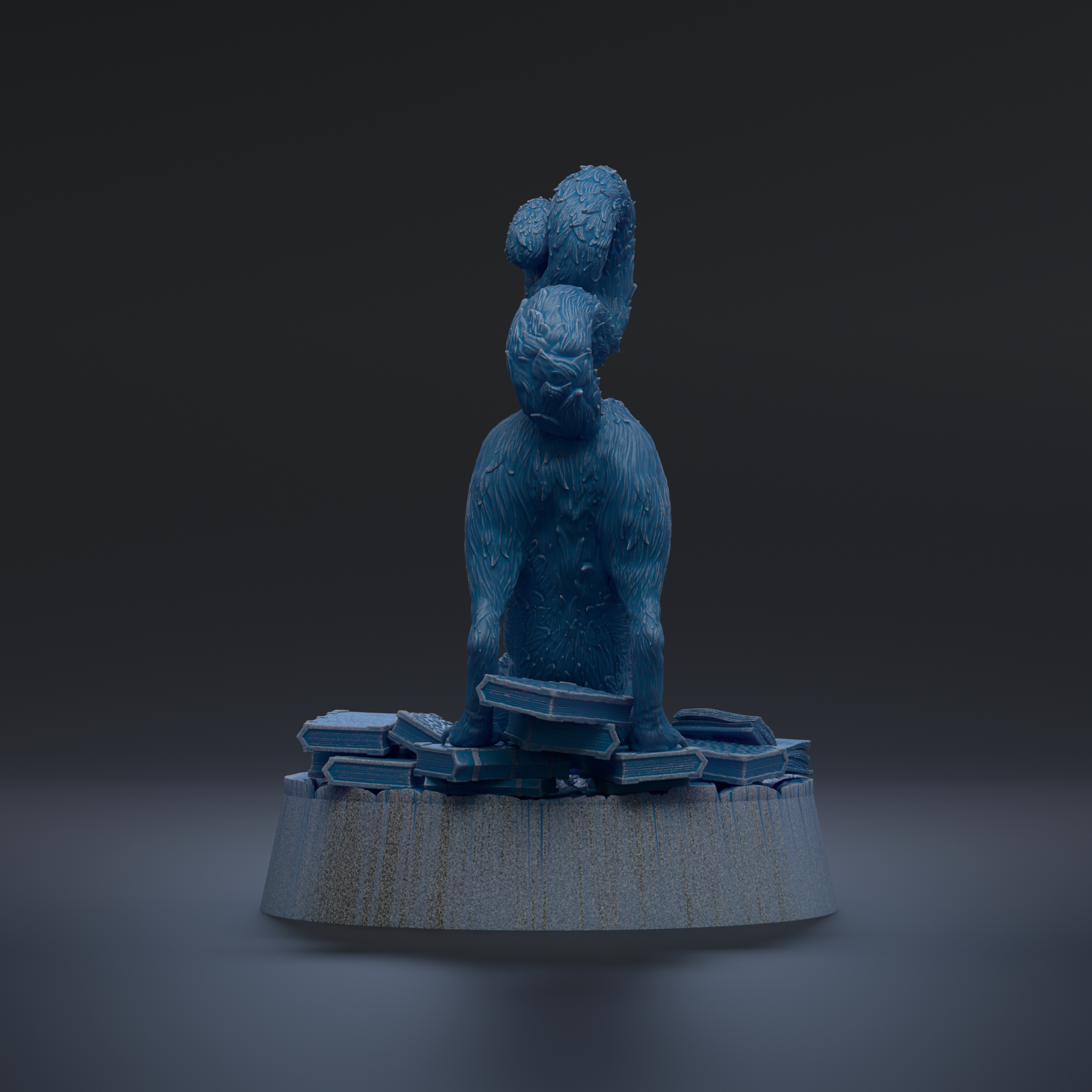 A blue, furry sculpture of a cat sitting on a pile of blue and white blocks, with a dark background.