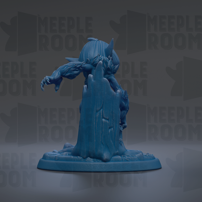 A blue figurine of a creature with sharp teeth and claws, standing on a base and facing away from the camera.