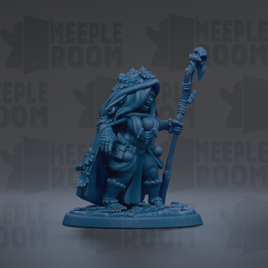 A blue figurine of a person holding a staff and wearing a hooded cloak, standing on a base.