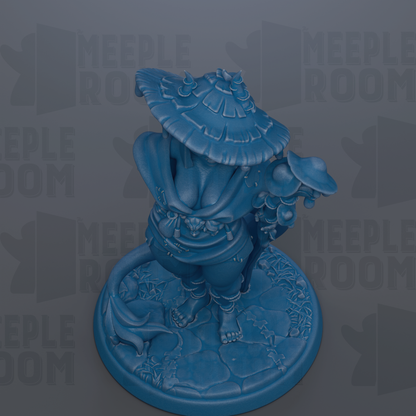 A blue figurine of a person wearing a hat and holding a parasol, standing on a stone base.