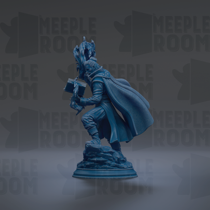 A blue statue of a person holding a book and standing on a rock.