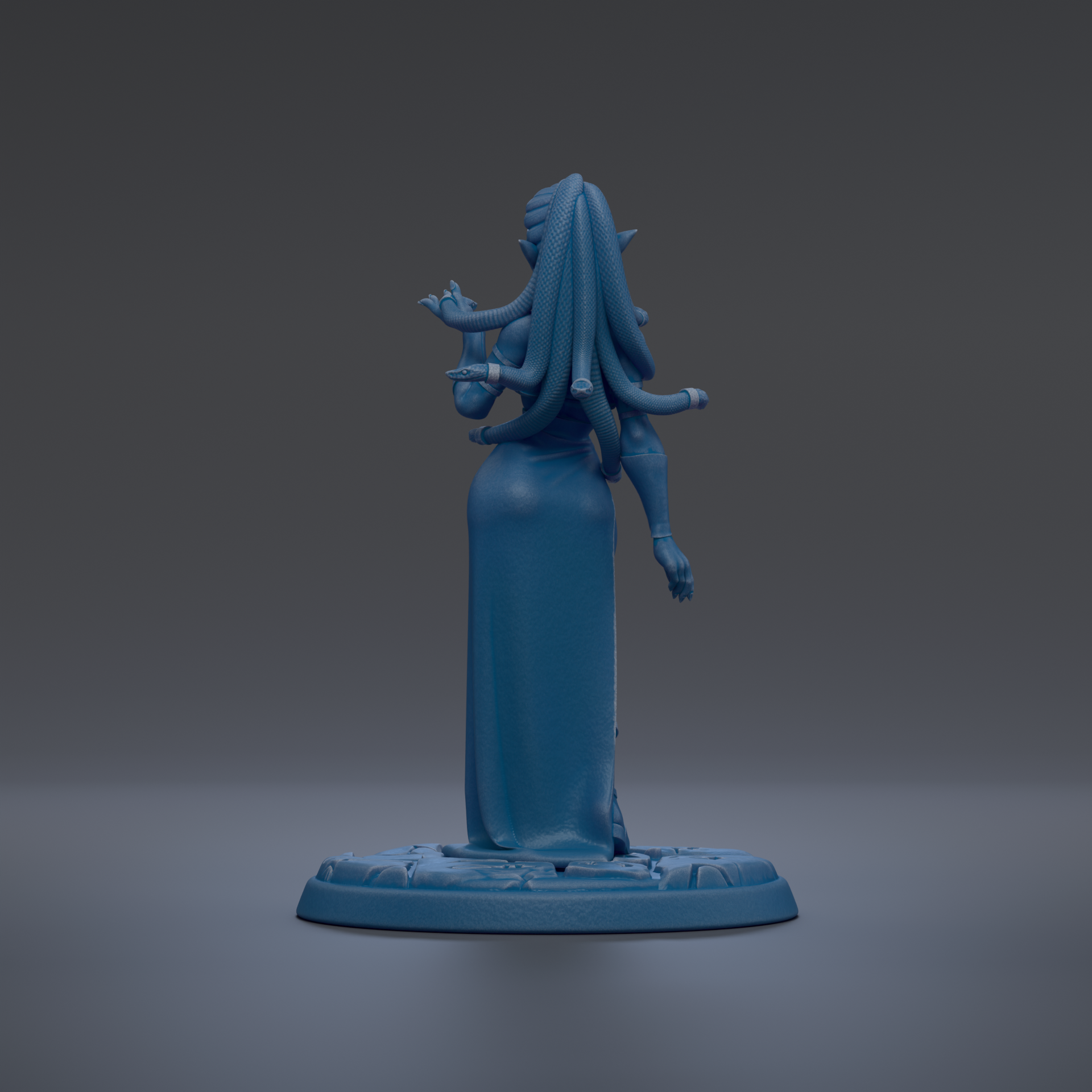 A blue figurine of a woman with long hair and a flowing dress stands on a base against a dark background.