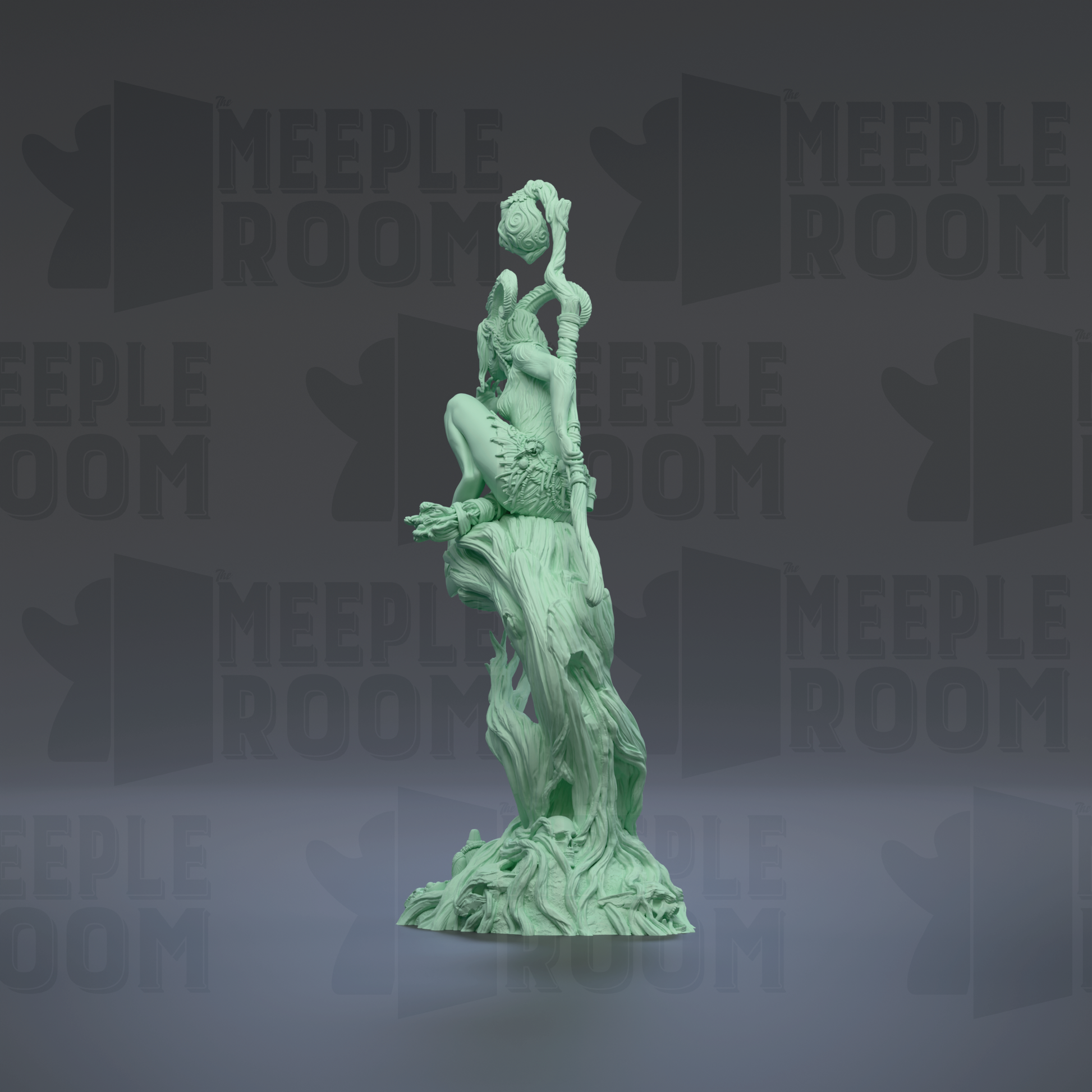 A green statue of a figure holding a staff and a ball, standing on a rock formation.