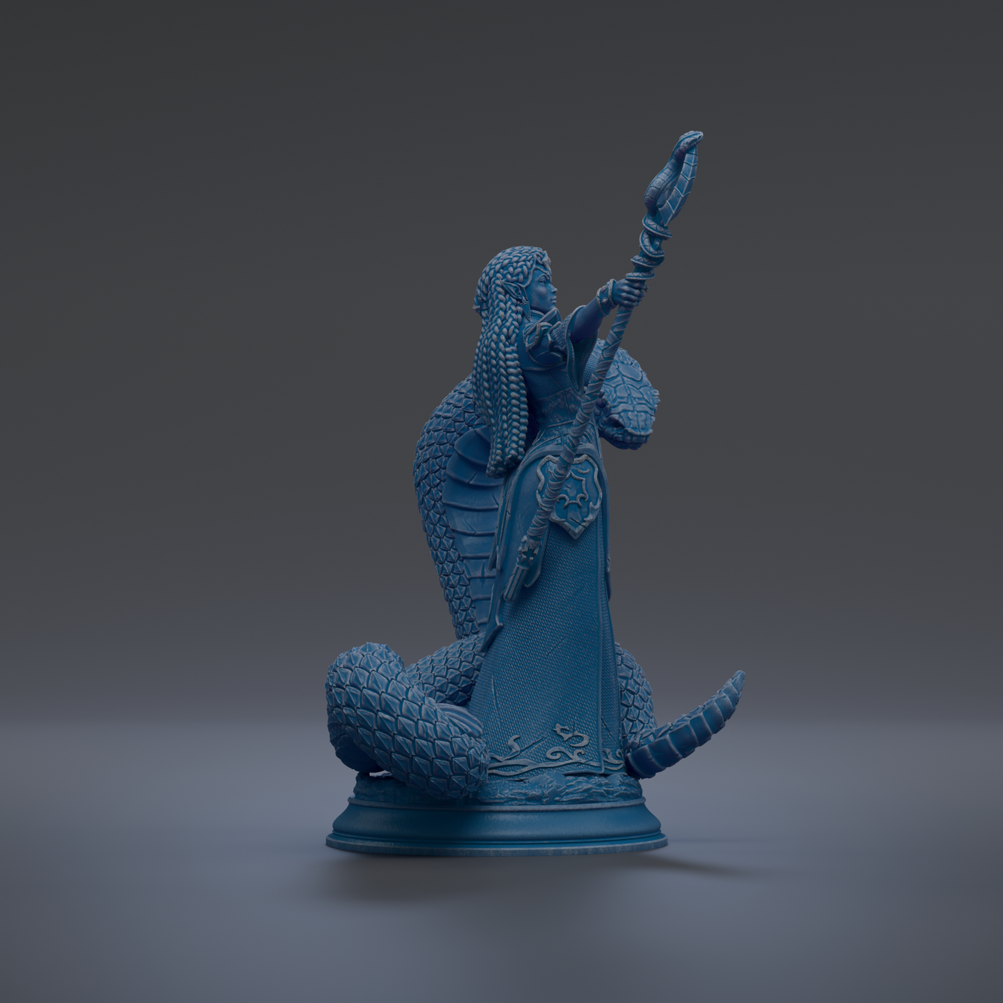 A blue statue of a figure holding a staff and a snake.