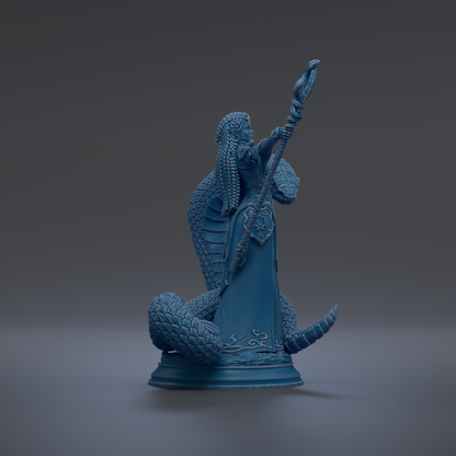 A blue statue of a figure holding a staff and a snake.