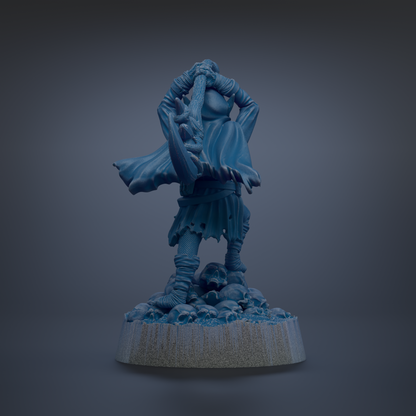 A blue figurine of a person holding a sword and standing on a rock formation against a dark background.