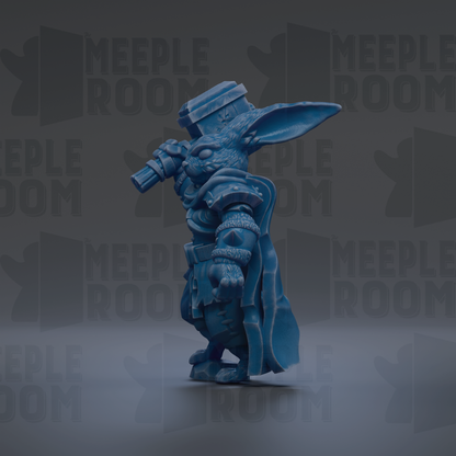 A blue, cartoonish-looking creature with a large head and a pointed hat, holding a camera in its right hand.