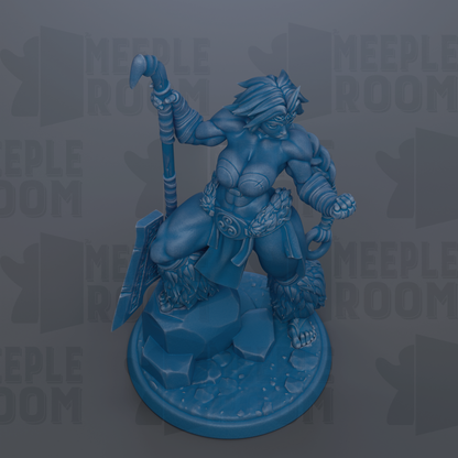 A blue figurine of a muscular, battle-ready warrior figure holding a spear and shield, standing on a rocky base.