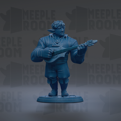 A blue figurine of a person playing a guitar.