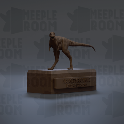 A 3D rendering of a dinosaur, specifically Nanotyrannus, standing on a platform with the text "NANOTYRANNUS Lane Cretaceous" below it.