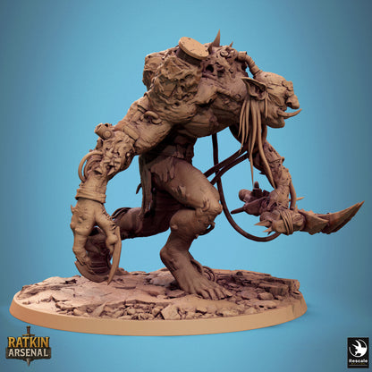 a large, detailed, and intricate statue of a creature with a fierce expression, standing on a rocky base.