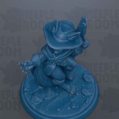 A blue figurine of a character with a cowboy hat and gun, sitting on a rocky surface.