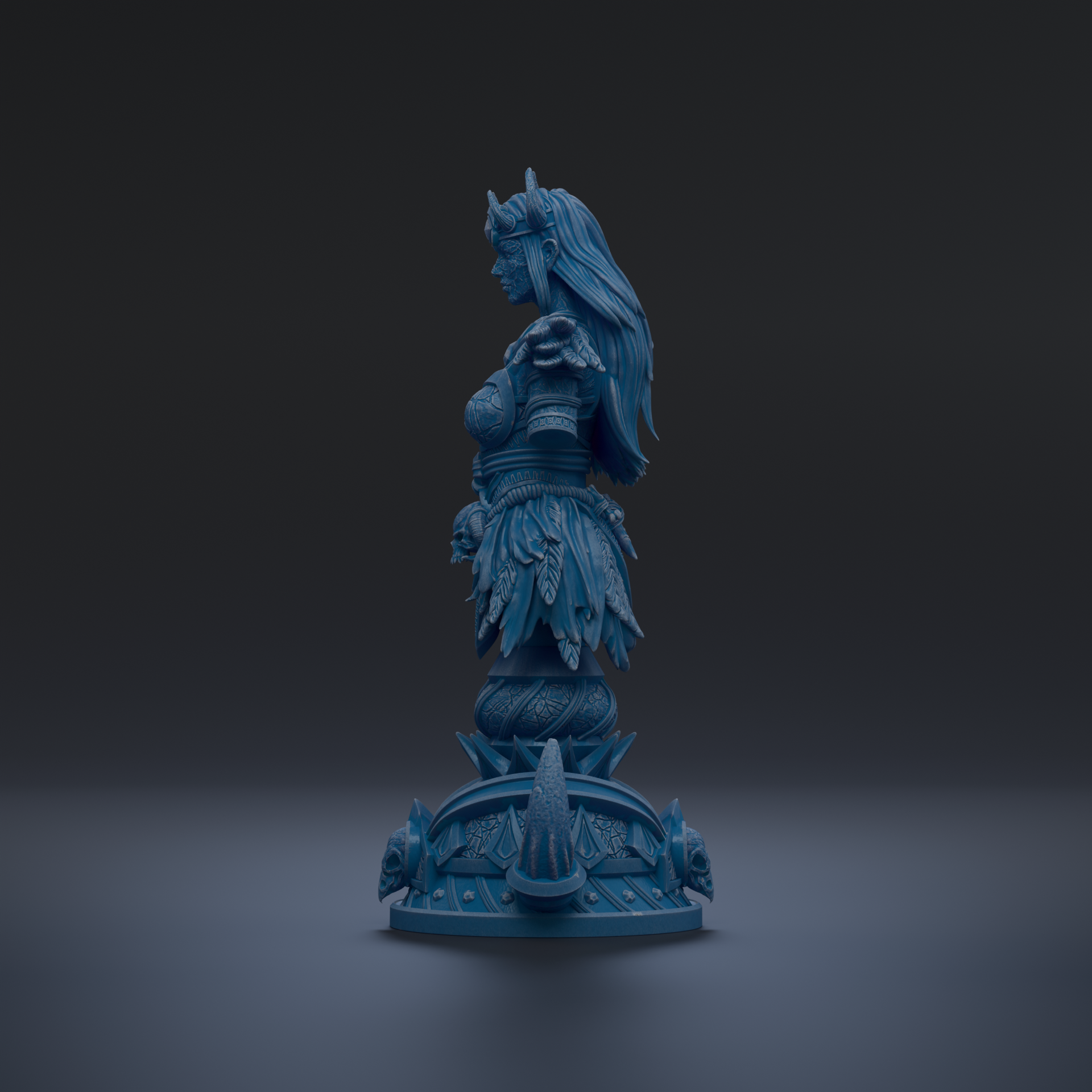 A blue statue of a woman with long hair and a crown, standing on a pedestal with intricate designs.