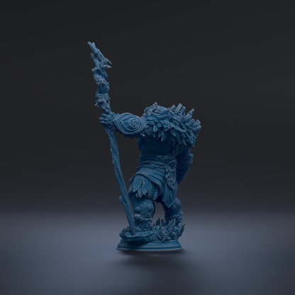A blue figurine of a fantastical creature, possibly a dragon or serpent, standing on a pedestal against a dark background.