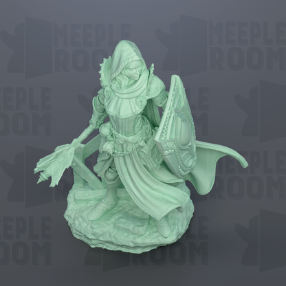 A green statue of a female character with a shield and a flowing robe, standing on a rock.