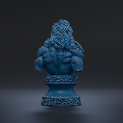 A blue bust sculpture of a muscular man with long hair, displayed on a decorative pedestal against a dark background.