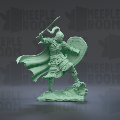 A green figurine of a warrior standing on a rock, holding a shield and sword, with a flowing cape.