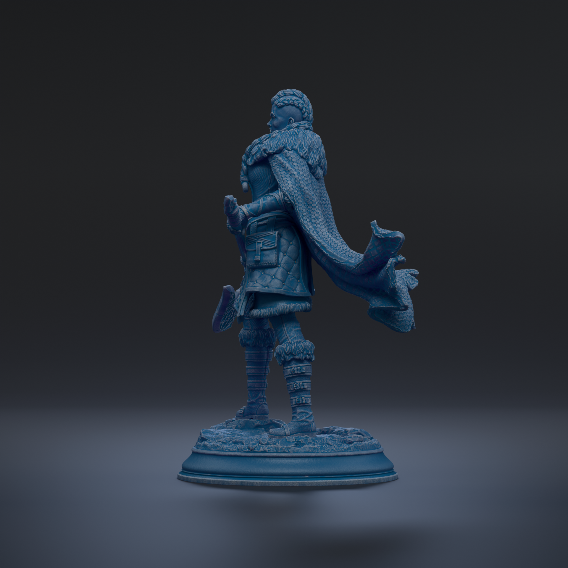 A blue statue of a person standing on a base, with a flowing cape.