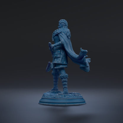 A blue statue of a person standing on a base, with a flowing cape.