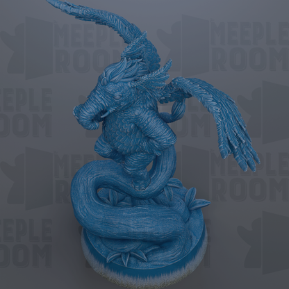 A blue dragon statue with wings spread, sitting on a rock.