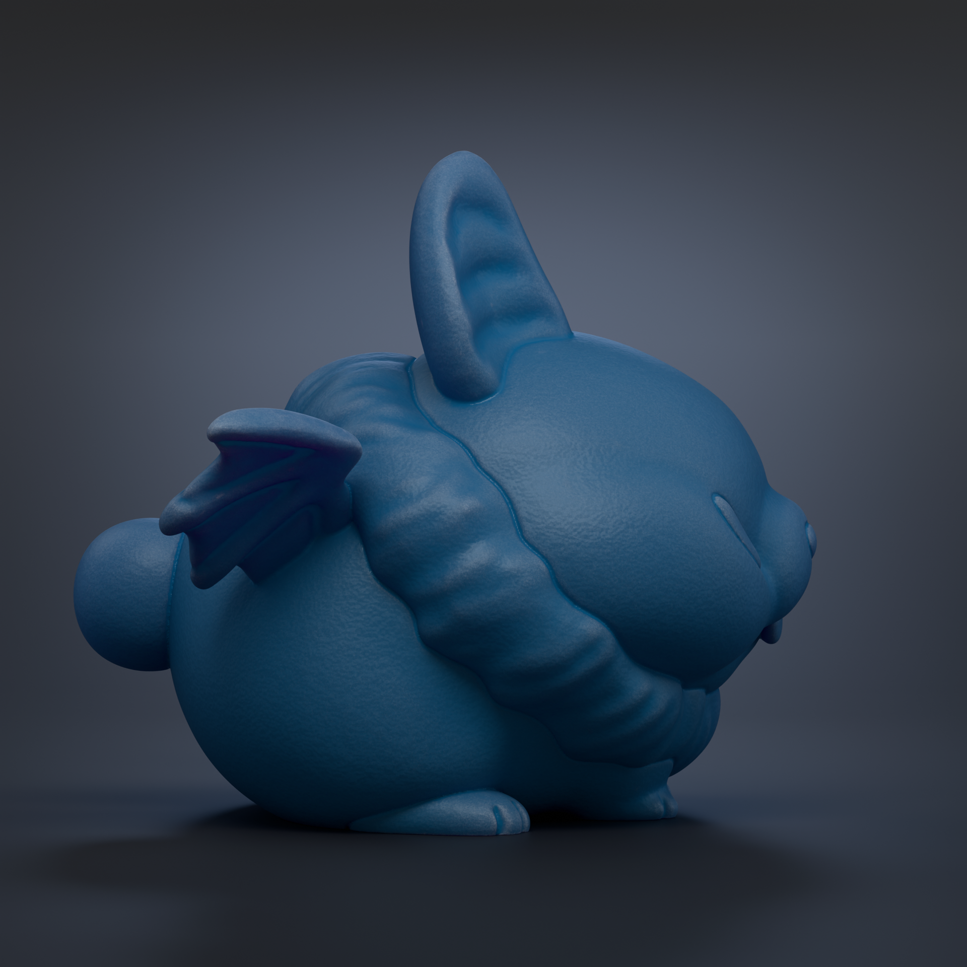 A blue, winged, cartoon-like rabbit figurine is shown against a dark background.