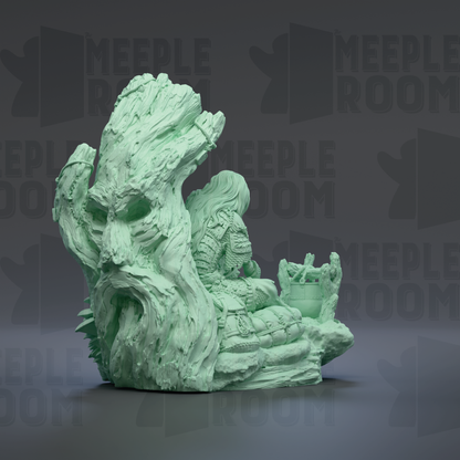 A large, intricate green sculpture resembling a tree or plant with a carved face and various other details.