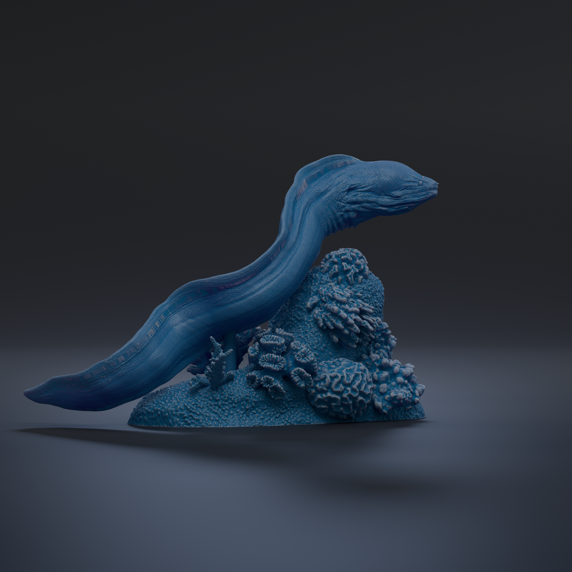 A blue, elongated, and textured object resembling a sea creature or sea monster, positioned on a rocky surface with some coral or other marine life.