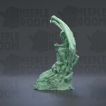 A green, sculpted statue of a human figure with an abstract, organic shape.