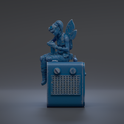 A blue fairy figurine sitting on top of a blue radio.