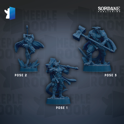 three figurines of characters from a video game, each with different poses and weapons.
