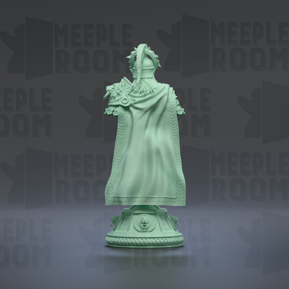 A green statue of a person wearing a flowing robe and headdress, standing on a pedestal.