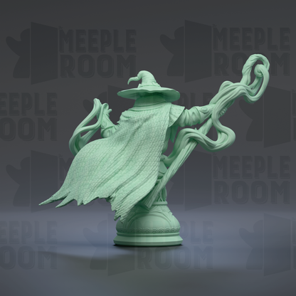A green statue of a wizard or magical figure, with flowing robes and a pointed hat, standing on a pedestal against a dark background with repeated text.