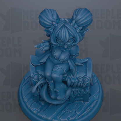 A blue figurine of a character with large ears and a unique hairstyle, sitting on a platform.